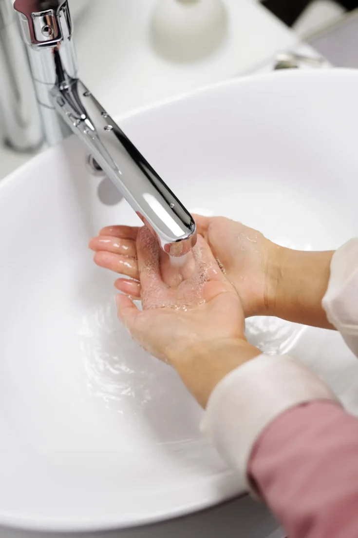 Woman washing her hands with soap